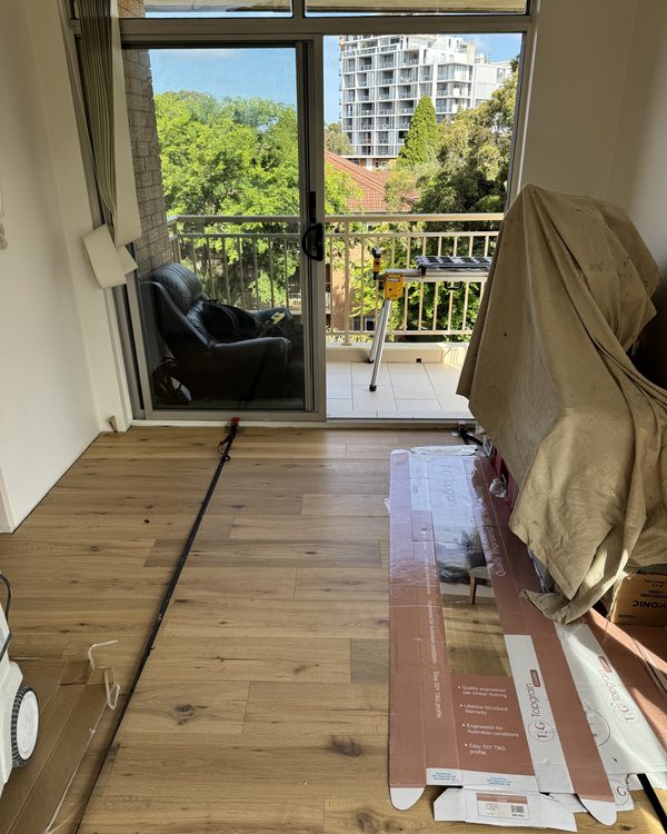 Engineered oak boards being laid in an apartment living room