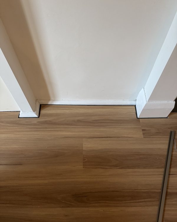 Timber flooring cut in neatly against painted skirting