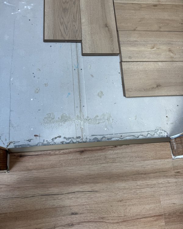 Boards set out against a prepared subfloor during installation