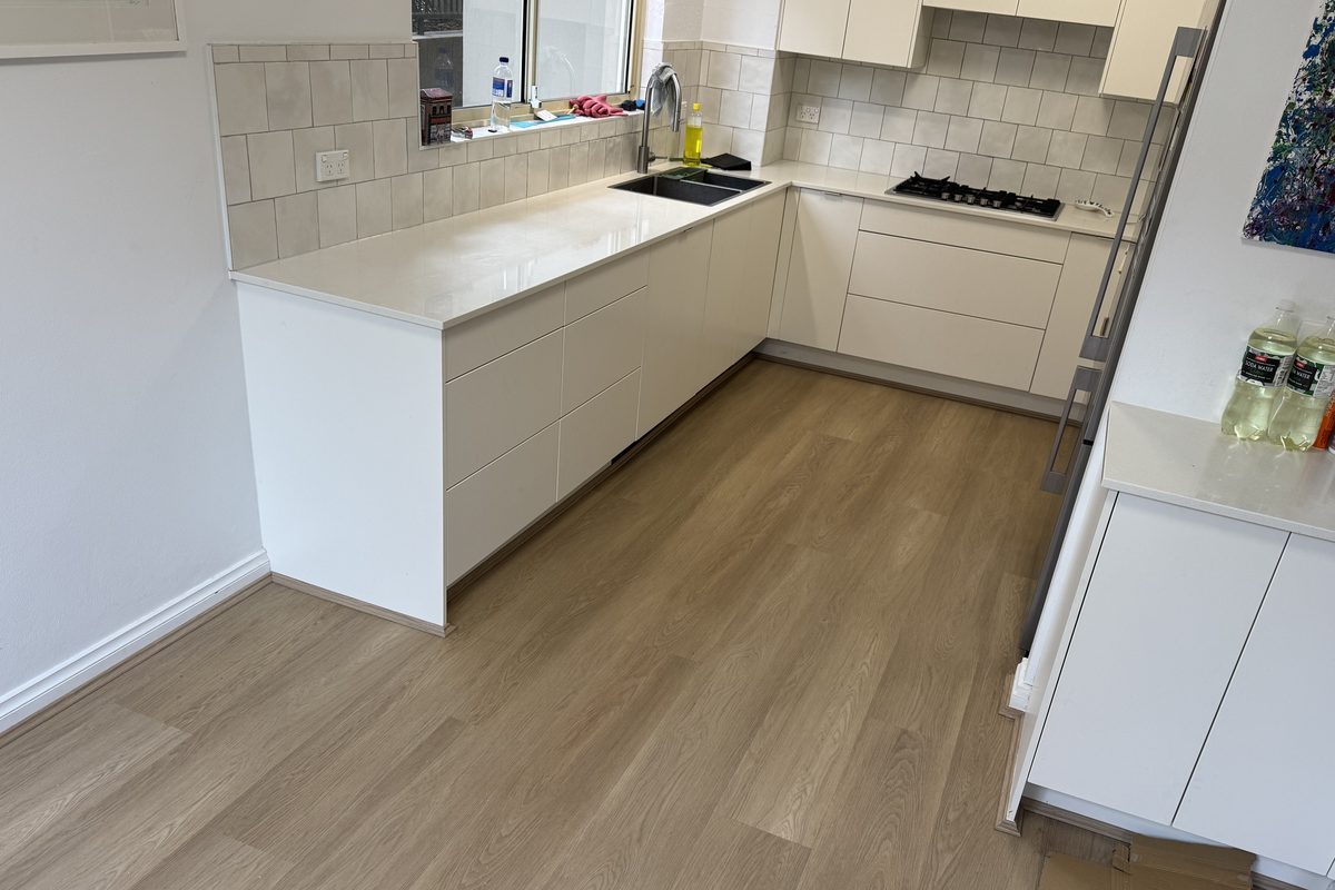 Light oak flooring running through a finished kitchen