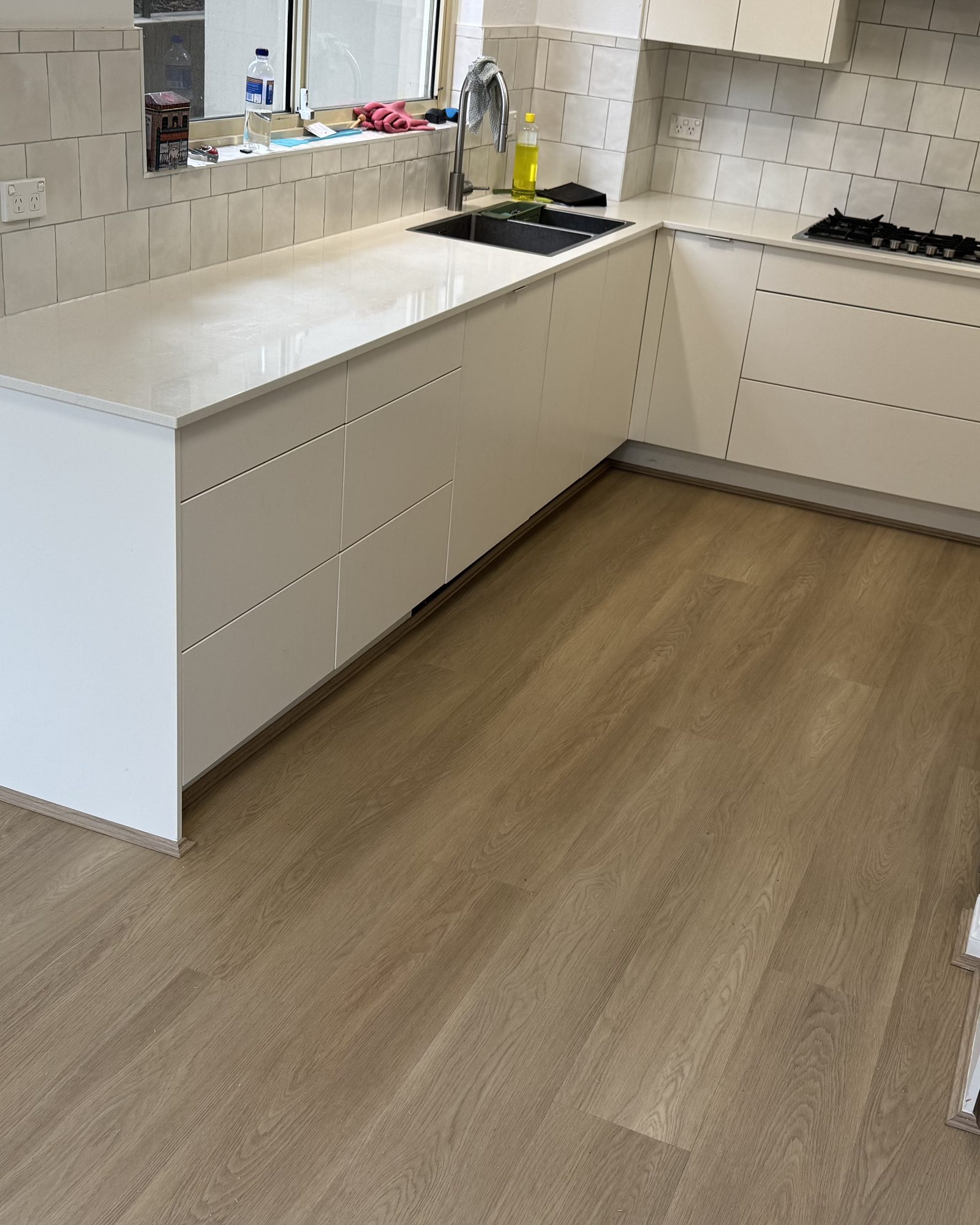 Light oak-look flooring running through a finished kitchen