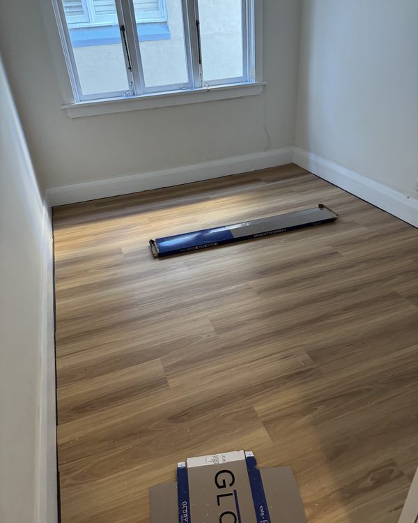 Hybrid plank flooring laid through a bedroom